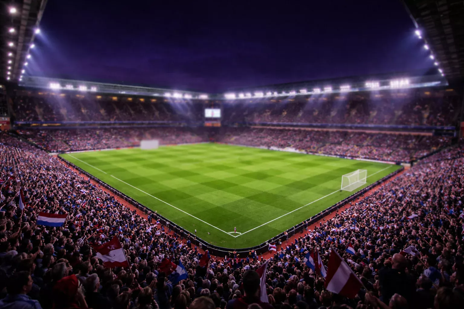 Vista panorámica del estadio Villa Park iluminado en noche de partido europeo